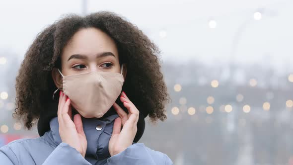 Portrait of Beautiful Stylish Ethnic Girl Wear Medical Face Mask on Cold Winter City Street
