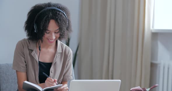 African Female Student Sits at Home on Couch, Study on E-learning Remotely From Room, Quarantine