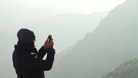 The guy on the observation deck looks at a beautiful view of the mountains