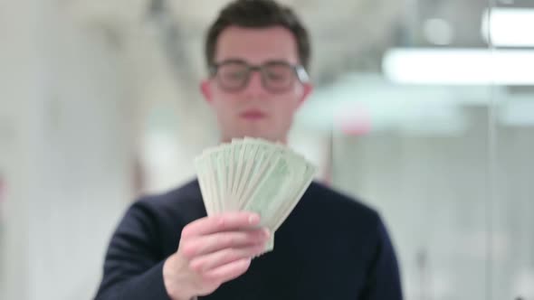 Professional Young Businessman Showing Dollars