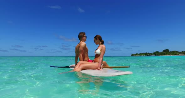 Beautiful people on honeymoon vacation spend quality time on beach on summer white sandy 4K background