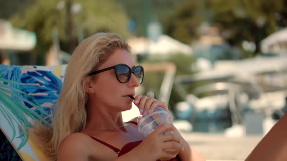 Girl Hiding From Sun Drinking Sipping For Healthy Refreshing Juice.Girl Drinking Coctail On Beach.