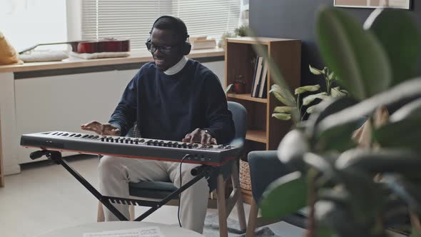 Happy Man Playing Synthesizer