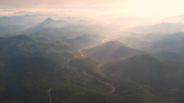 4K aerial view from a drone flying over the valley, fog in the morning.