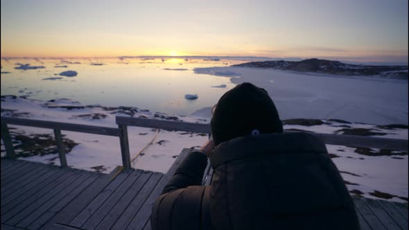 Photographer Adjusting Camera Tripod To Shoot Sunset