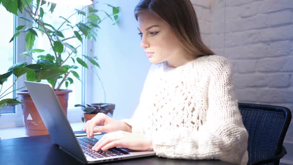 Young Female Upset By Loss While Working on Laptop