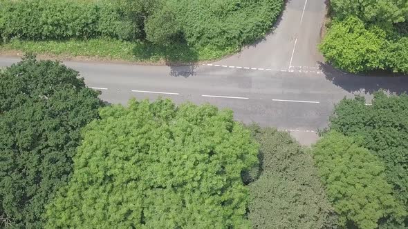 Aerial top shot pan of rural road on a summer day in Devon, UK, STATIC CROP