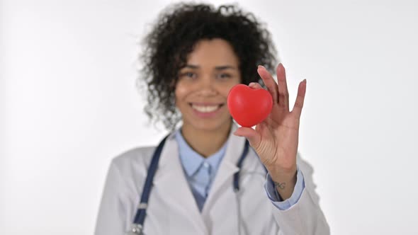 Portrait of Cheerful African Female Doctor Holding Heart Shape