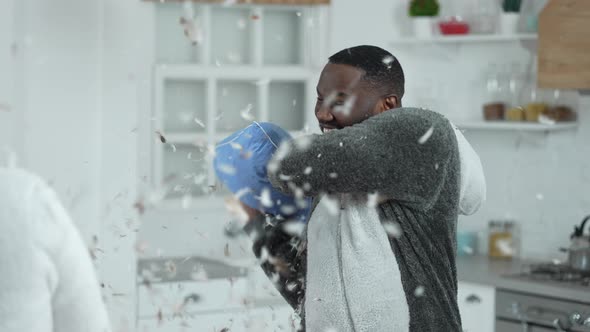 Multiethnic Couple Enjoying Pillow Fight at Home