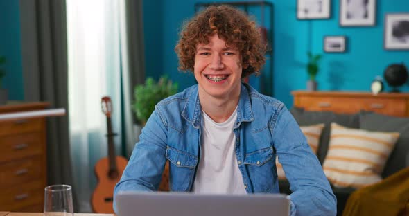 Portrait of a Handsome Caucasian Teenage Boy with Curly Hair