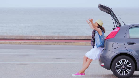 Woman Travels By Car, Relaxing at Seaside, Raised Her Hands Up