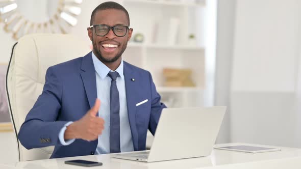 Positive African Businessman with Laptop Showing Thumbs Up