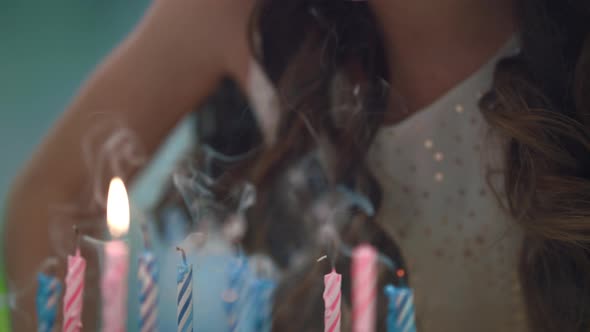 Girl Blowing Candles on Party Cake. Kids Birthday Celebration Tradition