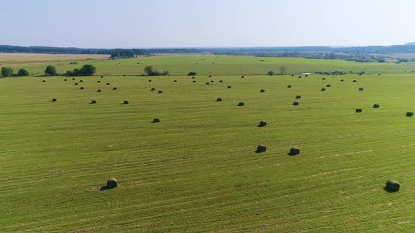 Flying above Field with Stacks - Drone Footage