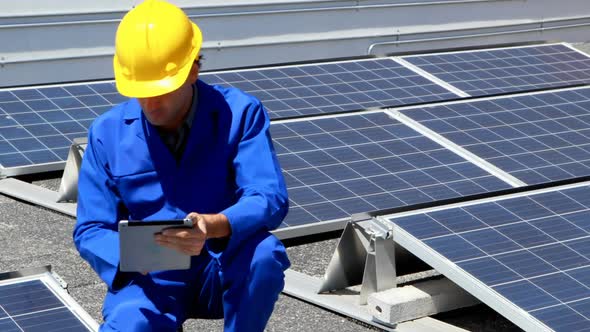 Male worker using digital tablet at solar station 4k