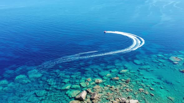 Aerial View of a Motor Boat Towing a Tube. Zakynthos, Greece