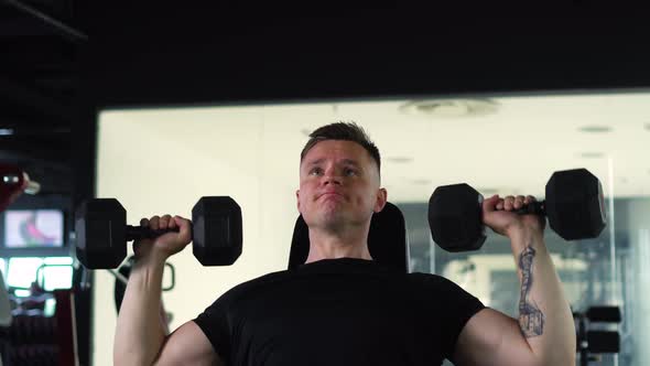 Muscular Man is Engaged in the Gym