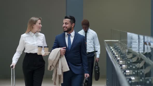 Business partners going inside terminal and speaking