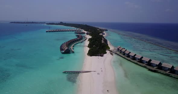 Natural flying copy space shot of a white sandy paradise beach and aqua blue water background in hig