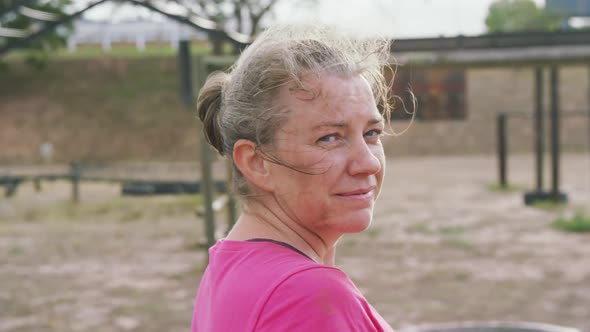 Caucasian woman looking at camera at boot camp