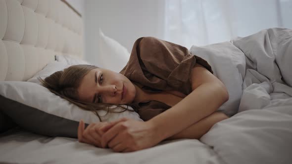 Woman Tries to Handle Sadness Lying on Bed After Waking Up