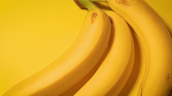 Fresh Bananas on a Yellow Minimalistic Background