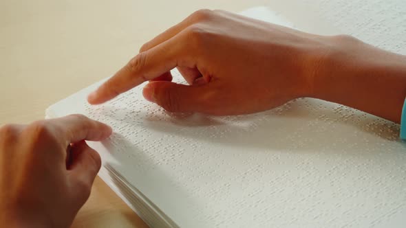 African American Man Reading Braille Book Closeup