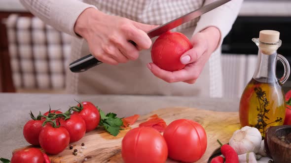 Woman Peels a Tomato Peel By Knife at Domestic Kitchen