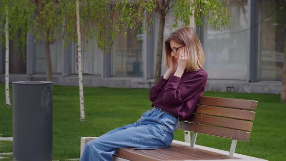 Young Caucasian woman suffering bad headache touching her temples