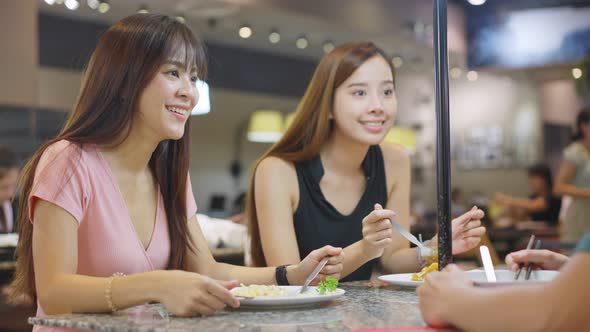 Asian young friend, beautiful woman and man having dinner enjoy eating food in restaurant together.