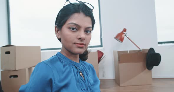 Young indian home owner woman looking into the camera