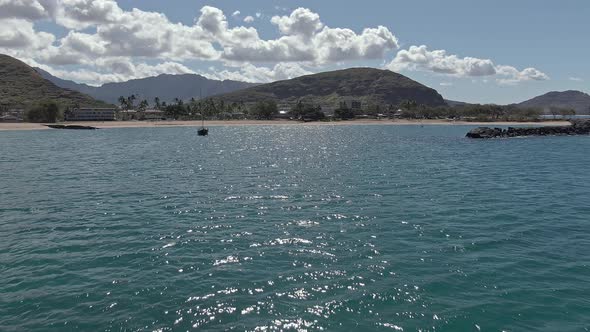 Low angle view of Pokai beach skimming across the shimmering ocean