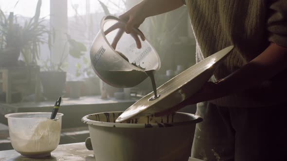 Ceramist Is Pouring Glaze On Plate