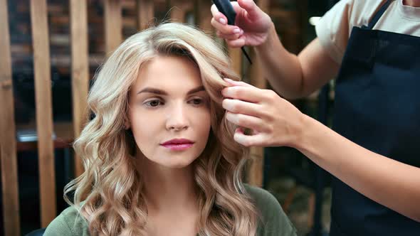 Face of Woman During Finishing Curly Hairstyle Use Comb