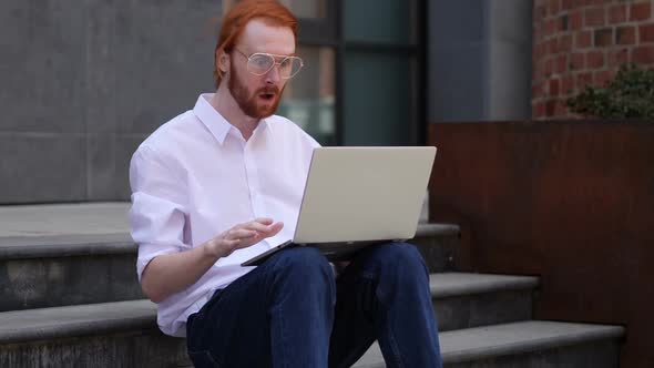 Wondering Designer Using Laptop While Sitting on Stairs Outside Office