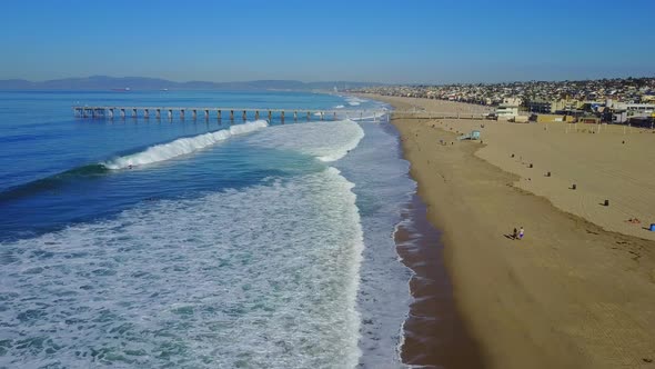 Aerial drone uav view of a pier over the beach and ocean.