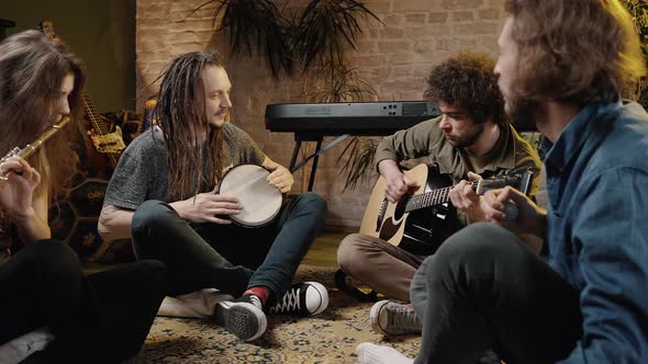 Group of Happy Creative Friends Performing Music Together Playing Musical Instruments Tracking Shot