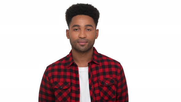 Portrait of Calm Relaxed African Young Man with Stylish Hairdo Posing on Camera Swallowing Over