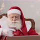 Santa Claus copying his credit card numbers when buying gifts on the internet. - VideoHive Item for Sale