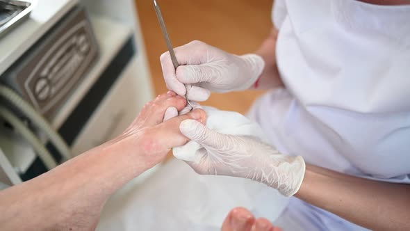 Professional Medical Pedicure Procedure Close Up Using Double Nail Instrument. Patient Visiting