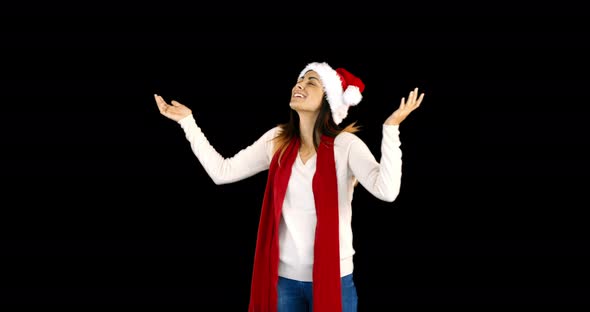 Woman in santa hat and warm clothing looking upwards 4k