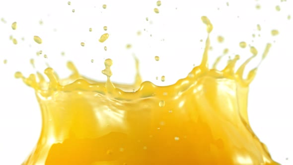 Super Slow Motion Shot of Orange Juice Splash Isolated on White Background at 1000Fps.