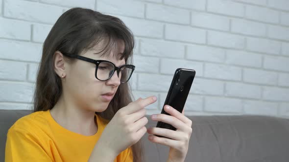 Child with Glasses with a Phone