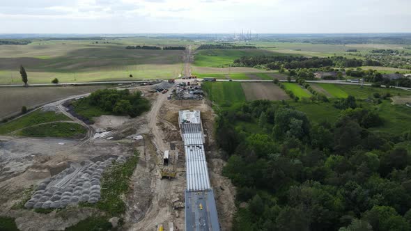 A Large Bridge Is Being Built With The Help Of Heavy Machinery And A Crane