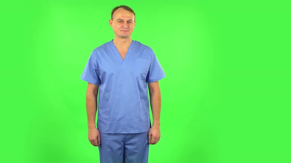 Medical Man Flirts and Winks While Looking at the Camera. Green Screen