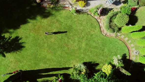 Aerial view of person in private garden around house.