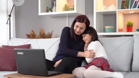 Video call of mother and daughter on laptop.