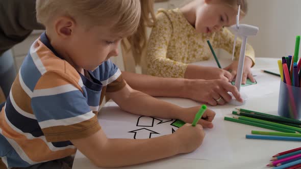 Tracking video of children coloring a recycle symbol. Shot with RED helium camera in 8K