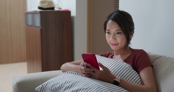 Woman use of smart phone for online at home