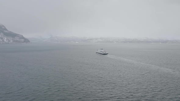 Ferry Sailing Across Kafjord From Olderdalen To Lyngseidet On A Foggy Winter Day In Norway. wide aer